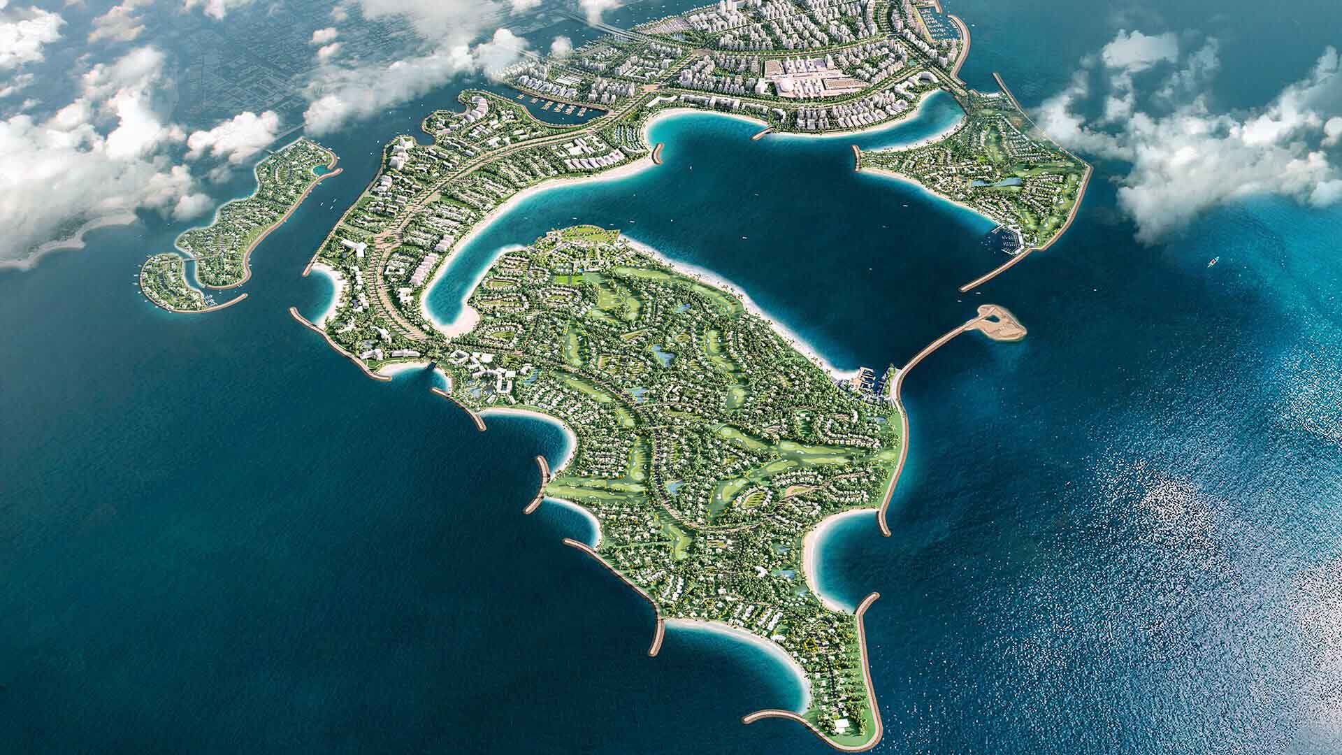 Communities Aerial view of an island with lush greenery, residential areas, and turquoise waters surrounding the coastline.